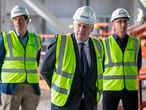 Britain's Prime Minister Boris Johnson (C) visits the construction site of the new dedicated Vaccines Manufacturing Innovation Centre (VMIC) currently under construction on the Harwell science and innovations campus near Didcot in central England on September 18, 2020. - The building is being constructed to manufacture vaccines for Covid-19 and is set to open next summer. (Photo by RICHARD POHLE / POOL / AFP)