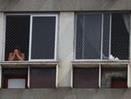 A man prays from his window as priest Jorge Luiz de Oliveira delivers the Angelus prayer from the balcony of the Santuario Basilica de Sao Sebastiao, following the coronavirus disease (COVID-19) outbreak, in Rio de Janeiro, Brazil May 6, 2020. REUTERS/Pilar Olivares