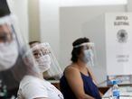 Election workers wear face shields and masks at a polling station during the municipal elections in Sao Paulo, Brazil, November 29, 2020. REUTERS/Amanda Perobelli