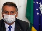 Brazil's President Jair Bolsonaro attends a meeting with Chamber of Deputies President Arthur Lyra to present a proposal for social programs at the Chamber of Deputies headquarters in Brasilia, Brazil, Monday, Aug. 9, 2021, amid the COVID-19 pandemic. The proposal aims to boost the government's flagship program coined "Bolsa Familia." (AP Photo/Eraldo Peres)