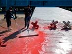 Employees clean red ink spilled by a protestor from the access ramp of the Planalto Palace, headquarters of the Brazilian government, in Brasilia on June 8, 2020, amid the new coronavirus pandemic. - The protestor was arrested. (Photo by Sergio LIMA / AFP)