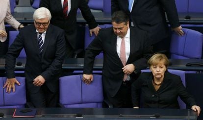 Angela Merkel no Bundestag com os titulares de Exteriores, Frank-Walter Steinmeier (esquerda), e Economia, Sigmar Gabriel.