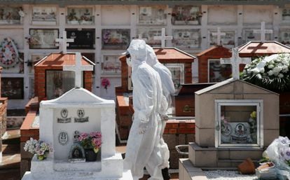 Trabalhadores puxam o caixão durante o sepultamento de uma vítima da covid-19, em um cemitério de Porto Alegre.