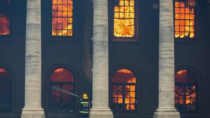 Bombeiro combate o incêndio que destruiu a Biblioteca Jagger, de quase 200 anos, no campus da Universidade da Cidade do Cabo (UCT), na África do Sul, no domingo.