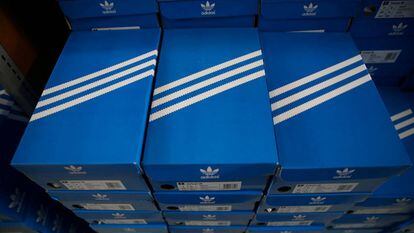 Pilha de caixas de tênis Adidas com o desenho das três listras.