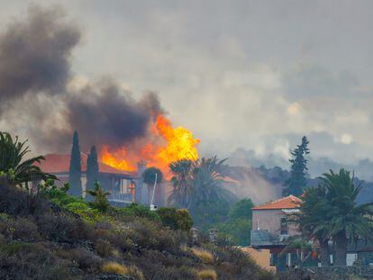 Uma casa queima pelos efeitos da erupção o vulcão de La Palma nesta segunda-feira, enquanto se observam no céu as nuvens de cinzas e gases geradas. Em vídeo, a lava devora moradias na ilha.