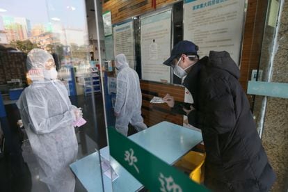 Um homem compra uma máscara em uma farmácia em Wuhan, na China, nesta quarta-feira, 29 de janeiro.