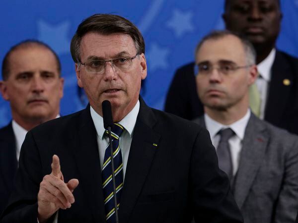 Brazil's President Jair Bolsonaro speaks during a press conference on the resignation of Justice Minister Sergio Moro, at the Planalto Presidential Palace in Brasilia, Brazil, Friday, April 24, 2020. Moro, who became popular as a crusader against corruption, resigned on Friday, alleging political interference in the federal police force. (AP Photo/Eraldo Peres)