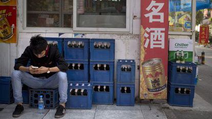 Trabalhador ao lado de caixas de cerveja em Pequim, China, um dos mercados onde a nova empresa poderá enfrentar problemas regulatórios.