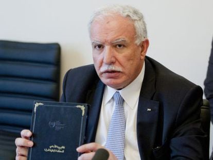 O ministro de Exteriores palestino, Riad al-Makli, com uma cópia do Estatuto de Roma.