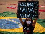 AME7133. BRASILIA (BRASIL), 31/03/2021.- Una mujer sostiene un cartel que dice "las vacunas salvan vidas" durante una protesta contra la dictadura militar y el gobierno del presidente de Brasil Jair Bolsonaro, hoy en Brasilia (Brasil). EFE/ Joedson Alves