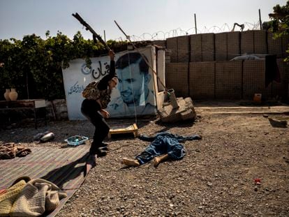 Soldado afegão golpeia o corpo sem vida de um militante do Talibã metralhado em Kandahar, em 10 de agosto.