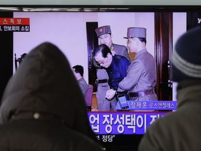 Dois sul-coreanos veem a notícia na televisão.