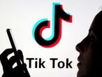 FILE PHOTO: A person holds a smartphone as TikTok logo is displayed behind in this picture illustration taken Nov. 7, 2019. REUTERS/Dado Ruvic/Illustration/File Photo