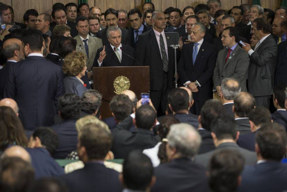 Michel Temer, rodeado de ministros e políticos, ao tomar posse como presidente interino no dia 12 de maio, em Brasília.
