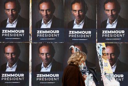 Uma mulher passa por cartazes do polemista Éric Zemmour em Paris, em 13 de outubro.