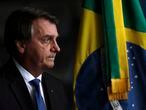 Brazil's President Jair Bolsonaro arrives to the Ministry of Justice to attend the inauguration of the new public defender, in Brasilia, Brazil, Tuesday, Jan. 19, 2021. (AP Photo/Eraldo Peres)