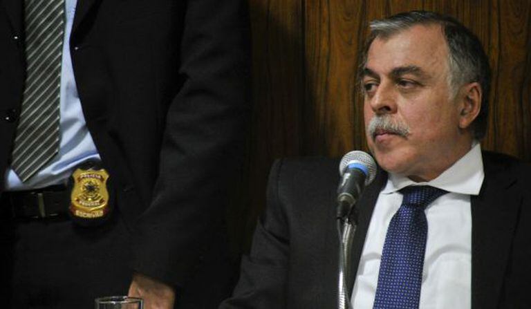 Paulo Roberto Costa, ao lado de um policial, na CPI da Petrobras.