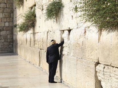 Donald Trump introduz um papel dobrado em uma das fendas dos blocos de pedra, num ritual em que normalmente são expressos desejos ou orações.
