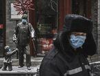 Un hombre con mascarilla en una calle de Pekín con los establecimientos cerrados, el miércoles.