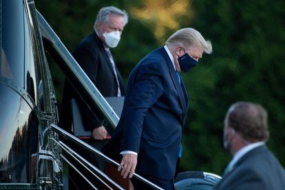 O Chefe de Gabinete da Casa Branca, Mark Meadows (à esquerda), observa o presidente Donald Trump deixar o Marine One ao chegar ao Walter Reed Medical Center em Bethesda, em 2 de outubro de 2020.