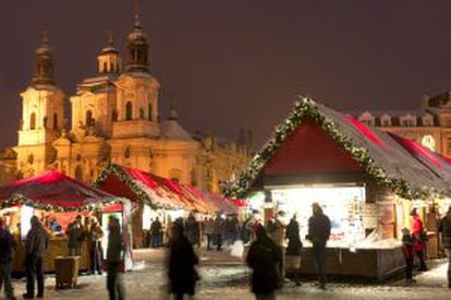 Mercadillo navideño na praça da Cidade Velha de Praga, com San Nicolás ao fundo.