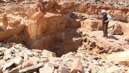 Pedreira de fósseis aberta por mineiros com barras de ferro e picaretas em Kaid Rami.