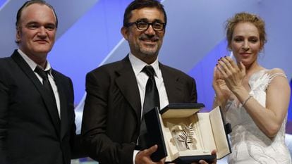 O diretor turco Nuri Bilge Ceylan recebe a Palma de Ouro ao lado do diretor Quentin Tarantino e da atriz Uma Thurman.