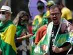 A supporter of Brazilian President Jair Bolsonaro shout slogans during a gathering commemorating the 1964 military coup that established a decades-long dictatorship, in the Ministries Esplanade in Brasilia, Brazil, Wednesday, March 31, 2021. The leaders of all three branches of Brazil's armed forces jointly resigned on Tuesday following Bolsonaro's replacement of the defense minister, causing widespread apprehension of a military shakeup to serve the president's political interests. (AP Photo/Eraldo Peres)