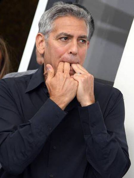 George Clooney assobia no posado ante os fotógrafos em Veneza.