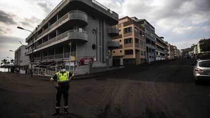 Um agente em frente a edifícios em Las Manchas, na zona de exclusão ao redor do vulcão de La Palma, nesta quarta-feira.