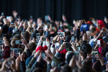 Uma multidão fotografa um ato com seu móvel.