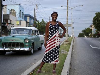 Jovem cubana vestida com a bandeira norte-americana em Havana.