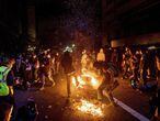 Demonstrators burn garbage in Oakland, Calif., on Friday, May 29, 2020, while protesting the Monday death of George Floyd, a handcuffed black man in police custody in Minneapolis. (AP Photo/Noah Berger)