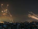 Rockets are seen in the night sky fired towards Israel from Beit Lahia in the northern Gaza Strip on May 14, 2021. - Israel pounded Gaza and deployed extra troops to the border as Palestinians fired barrages of rockets back, with the death toll in the enclave on the fourth day of conflict climbing to over 100. (Photo by ANAS BABA / AFP)