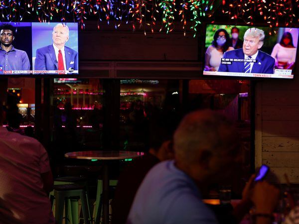 The dual town halls of U.S. Democratic presidential candidate Joe Biden and U.S. President Donald Trump, who are both running in the 2020 U.S. presidential election, are seen on television monitors at Luv Child restaurant ahead of the election in Tampa, Florida, U.S. October 15, 2020.  REUTERS/Octavio Jones