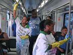 Workers disinfect handrails on a train as a precautionary measure against the spread of the new coronavirus, COVID-19, at Rio de Janeiro's Central train station, in Brazil, on March 16, 2020. (Photo by Carl DE SOUZA / AFP)