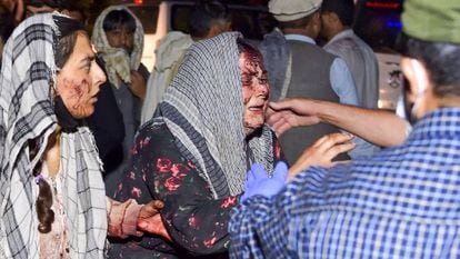 Uma mulher ferida chega ao hospital depois das duas explosões desta quinta-feira perto do aeroporto da capital afegã.