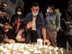 People lights candle outside the Notre-Dame de l'Assomption Basilica in Nice on October 29, 2020 in tribute to the three victims of a knife attacker, cutting the throat of at least one woman, inside the church of the French Riviera city. (Photo by Valery HACHE / AFP)