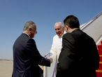 Iraqi Prime Minister Mustafa Al-Kadhimi welcomes Pope Francis at Baghdad International Airport, in Baghdad, Iraq March 5, 2021. Iraqi Prime Minister Media Office/Handout via REUTERS ATTENTION EDITORS - THIS IMAGE WAS PROVIDED BY A THIRD PARTY.
