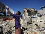 Mulher estende roupa entre os escombros do terremoto do Haiti, em 2010.