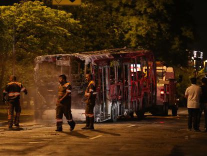 T&eacute;cnicos retiram &ocirc;nibus incendiado na zona norte de S&atilde;o Paulo.