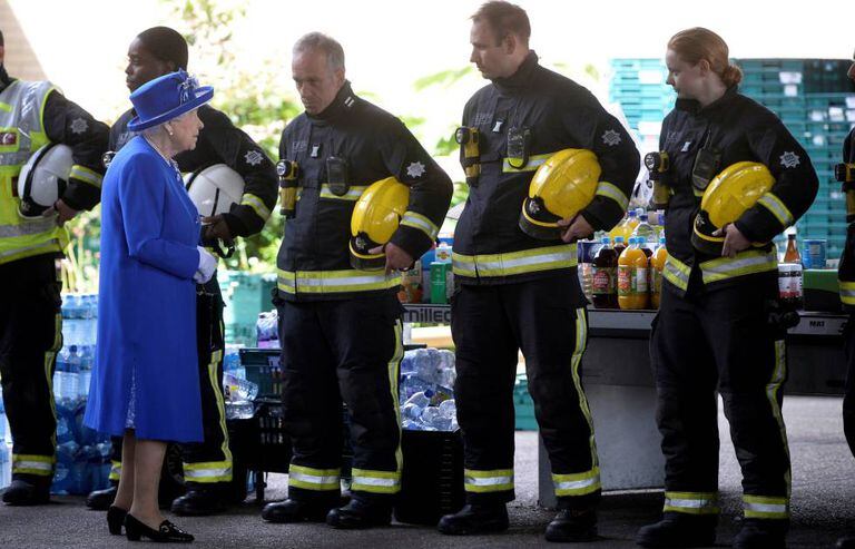 A rainha da Inglaterra Elizabeth II cumprimenta os bombeiros de Londres.