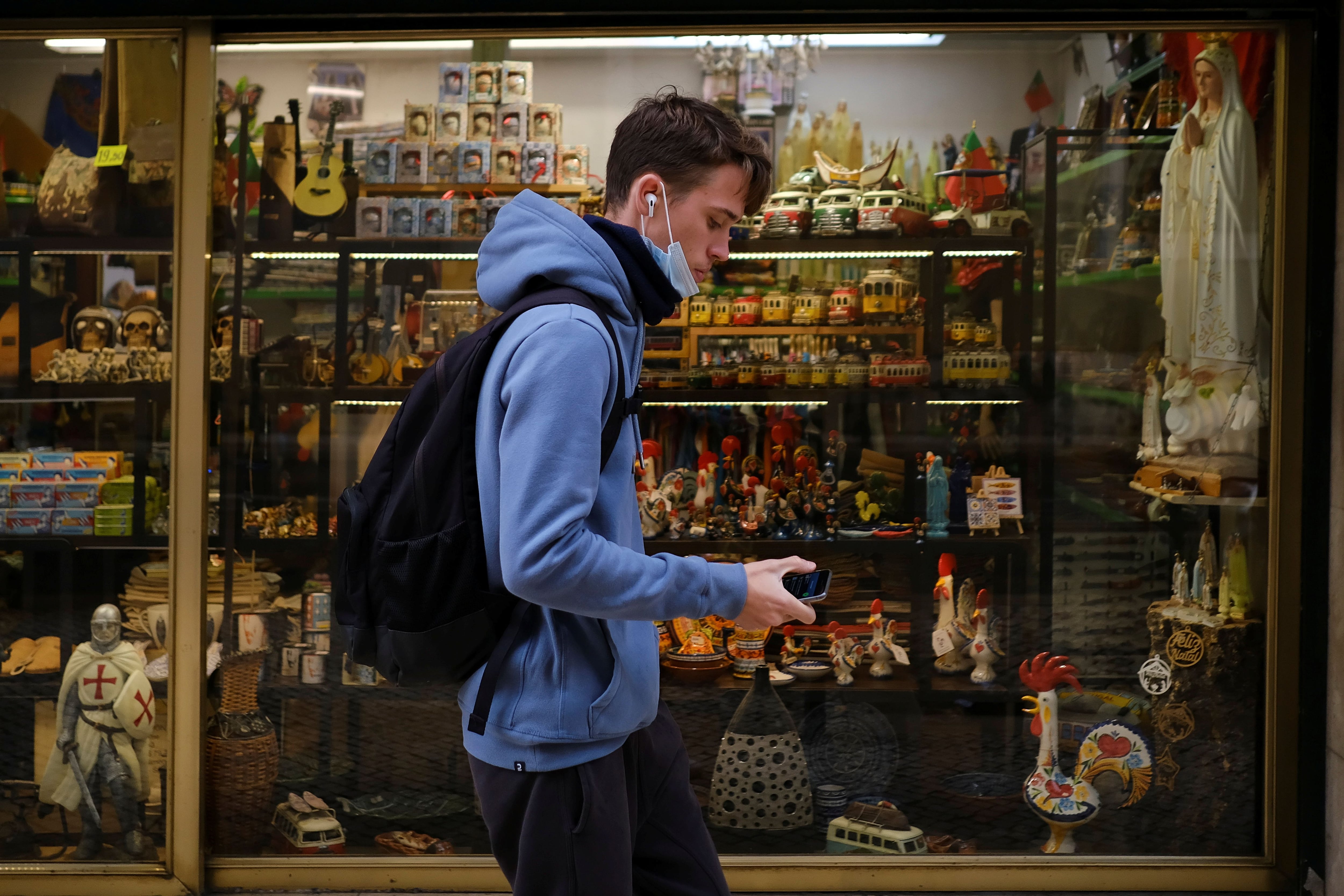 Um homem anda em frente a uma loja no centro de Lisboa, nesta quinta-feira.