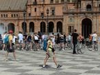A tourist wearing a protective mask walks at Plaza de Espana in Seville on March 11, 2020 after Spain banned all air traffic from Italy, closed schools and blocked fans from football matches due to the coronavirus outbreak. - Coronavirus infections in Spain have passed the 2,000 mark with 47 deaths, the health ministry announced, making it Europe's second most severe outbreak after Italy. (Photo by CRISTINA QUICLER / AFP)