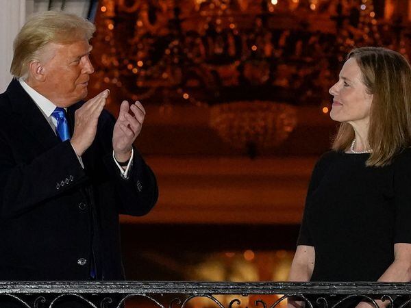 President Donald Trump and Amy Coney Barrett stand on the Blue Room Balcony after Supreme Court Justice Clarence Thomas administered the Constitutional Oath to her on the South Lawn of the White House White House in Washington, Monday, Oct. 26, 2020. Barrett was confirmed to be a Supreme Court justice by the Senate earlier in the evening. (AP Photo/Alex Brandon)
