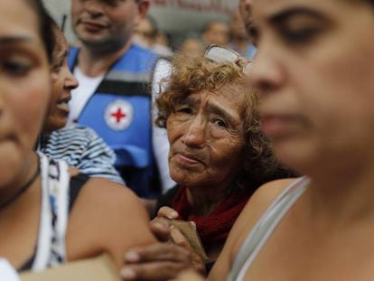 Venezuelanos esperam para receber água filtrada e medicamentos distribuídos pela Cruz Vermelha em Caracas. 