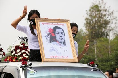 Birmanesas seguram um retrato de Mya Thwate Thwate Khaing, uma manifestante morta a tiros por policiais durante os protestos em Mianmar, durante o cortejo fúnebre da jovem, em 21 de fevereiro.