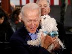 U.S. Democratic presidential candidate and former Vice President Joe Biden gets licked by a dog as he chats with supporters after speaking at his party after the Nevada Caucus in Las Vegas, Nevada, U.S., February 22, 2020. REUTERS/Patrick T. Fallon