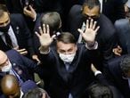 Brazilian President Jair Bolsonaro waves as he leaves the National Congress after a plenary session of the Chamber of Deputies, in Brasilia, on February 3, 2021. - The Brazilian Congress on Monday elected two allies of President Jair Bolsonaro to head the Senate and the lower house, an important victory for the far-right leader in his quest to reinvigorate his reelection efforts for 2022. (Photo by Sergio Lima / AFP)